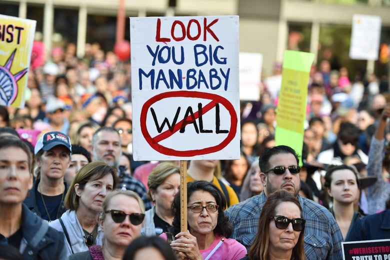Protesters hold signs during the Women's March on January 19, 2019 in Los Angeles, California.